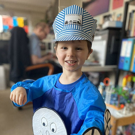 child wearing a blue striped train conductor hat  and homemade train costume.