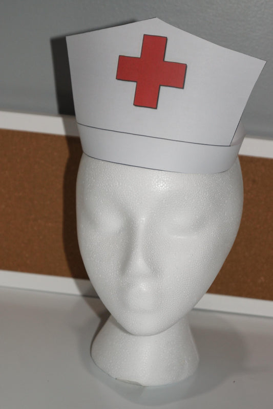White printable nurse hat with red cross displayed on a mannequin head for community helper and dramatic play activities
