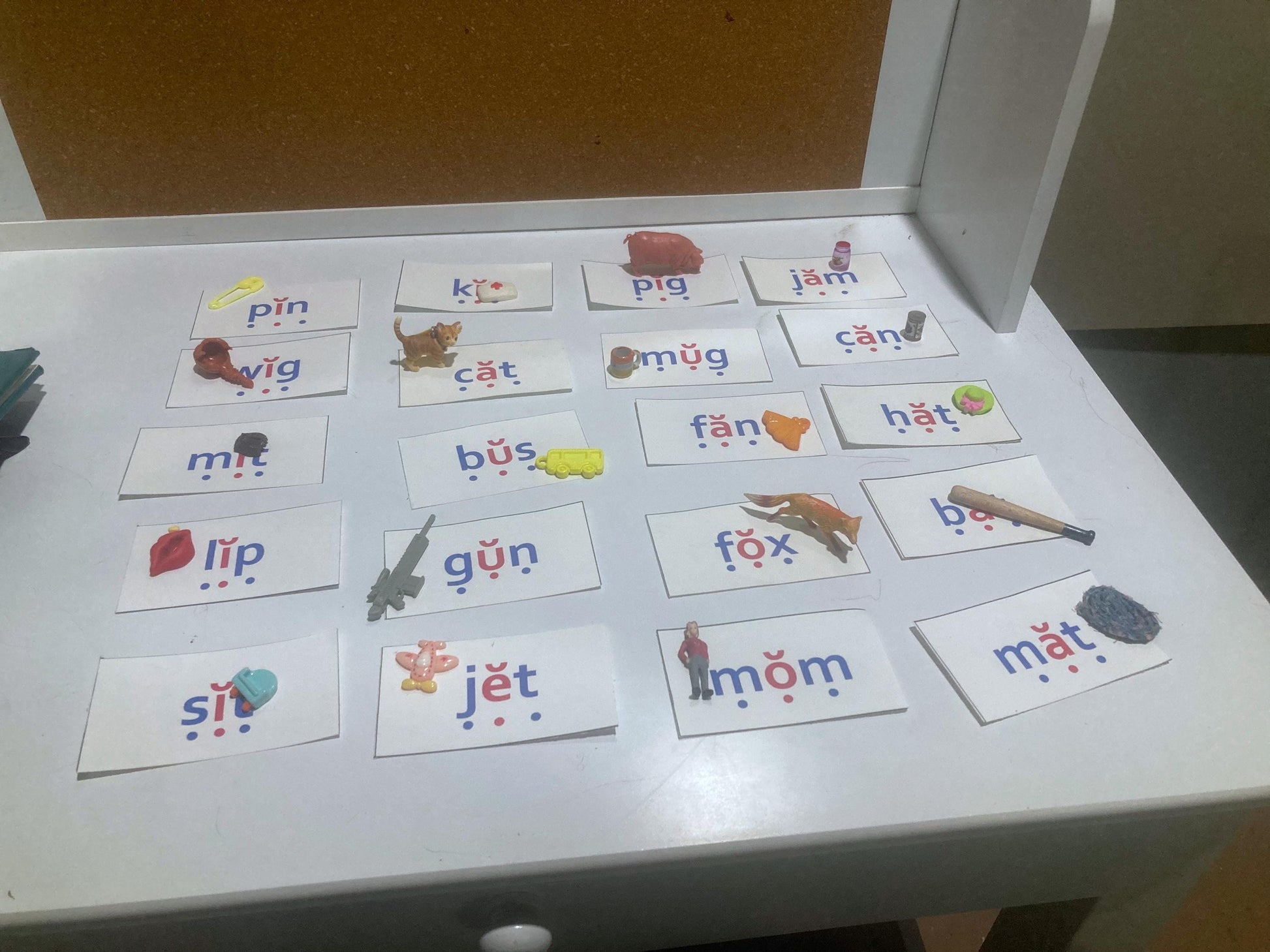 Science of Reading aligned, decodable flashcards with miniature figurines on a white desk.