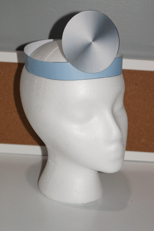 Printable doctor’s hat with blue band and silver head mirror displayed on a white mannequin head, perfect for community helper and dramatic play centers.
