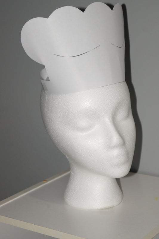 Printable classic white chef’s hat displayed on a white mannequin head, perfect for community helper and dramatic play centers.